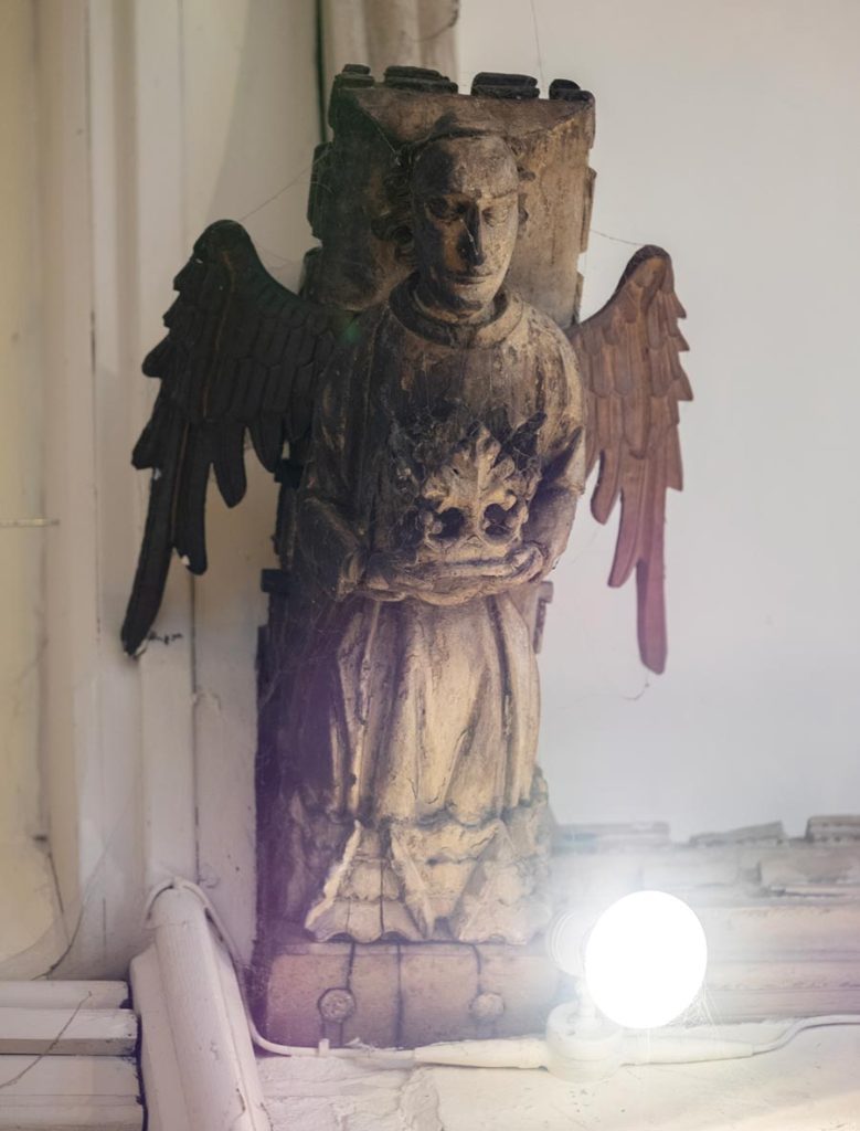 Angel (half-singed) holding crown? / Tree of life?