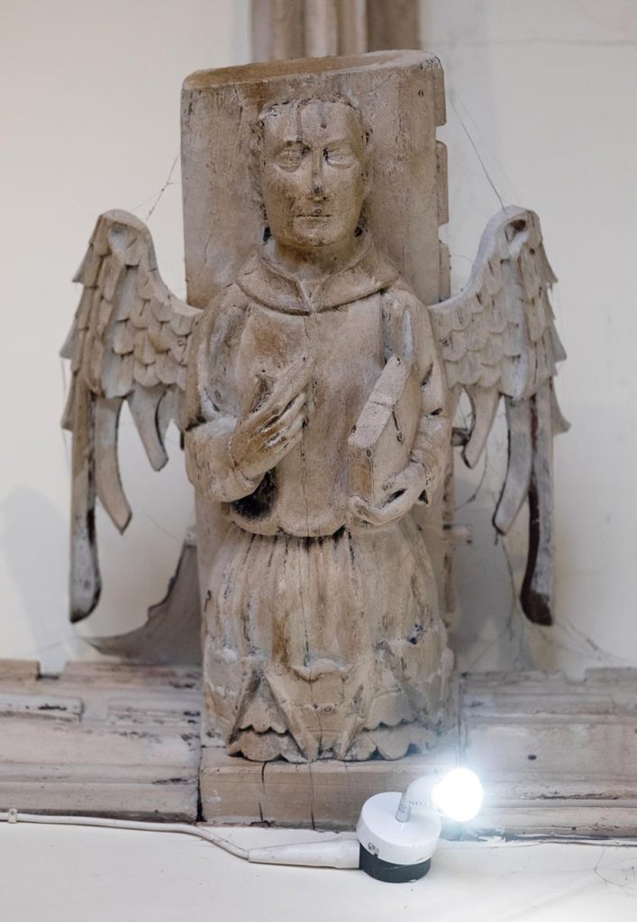 Angel holding closed book?