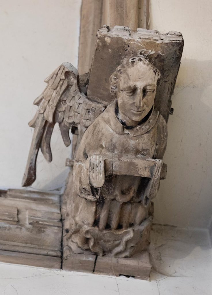 Angel holding closed book