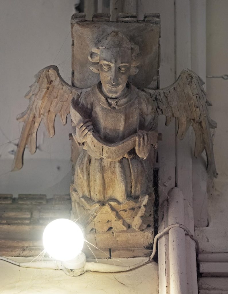 Angel singing from open music book