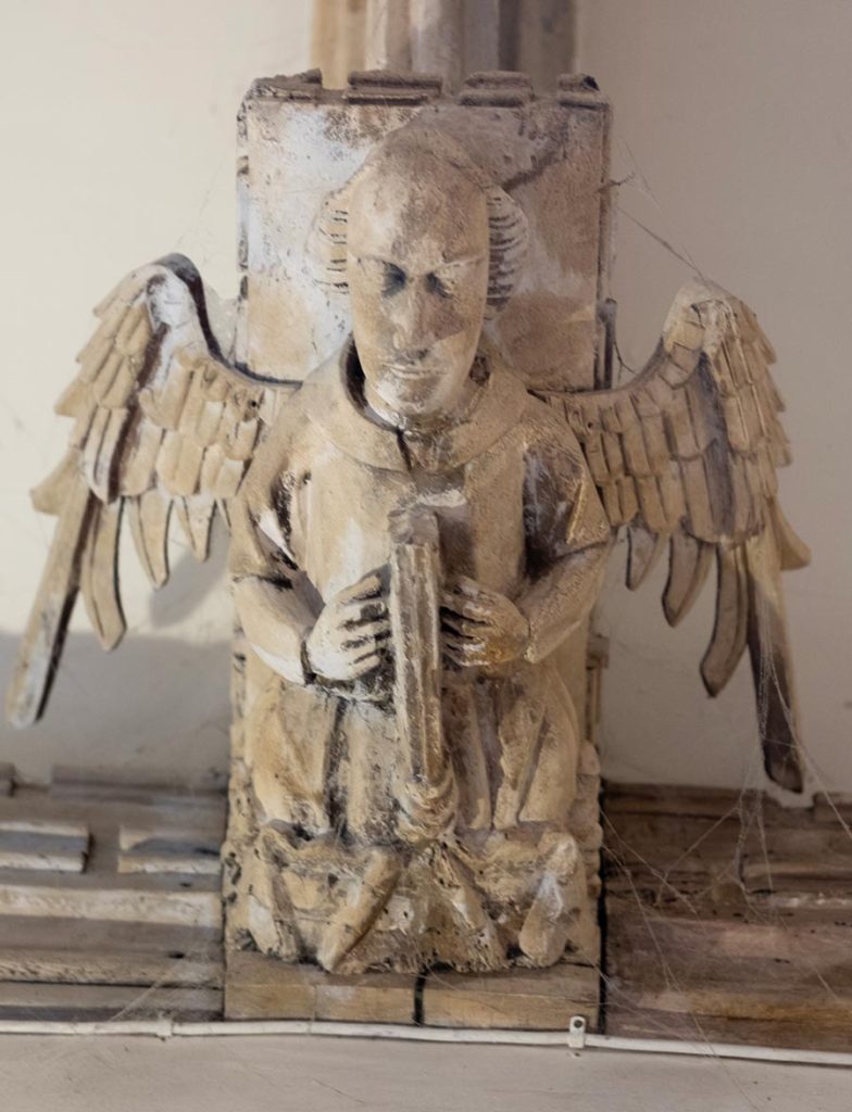 Angel holding closed book
