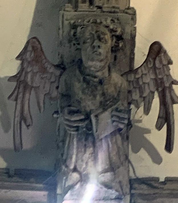 Angel holding closed book