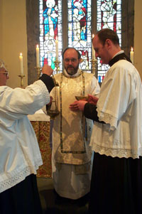 The celebrant goes up to the altar